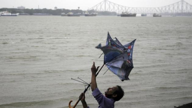 A man saves his umbrella during the rain and wind in Kolkata on May 20. The cyclonic storm triggered torrential rain in the capital city of West Bengal causing destruction all around. (ANI)