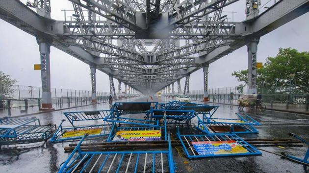 Police barricades collapsed to the ground at Howrah Bridge after strong winds swept Kolkata as Cyclone Amphan made its landfall on May 20 in West Bengal. Amphan is the strongest cyclone to have originated from the Bay of Bengal in decades. (PTI)