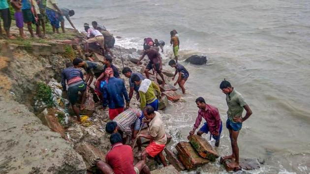 Villagers repair a bank that was destroyed by sea waves at Bakkhali due to the landing of Cyclone Amphan, near Sunderbans area in South 24 Parganas district of West Bengal, Wednesday, May 20, 2020. (PTI photo) Villagers repair a bank that was destroyed by sea waves at Bakkhali due to the landing of Cyclone Amphan, near Sunderbans area in South 24 Parganas district of West Bengal, Wednesday, May 20, 2020. (PTI photo)