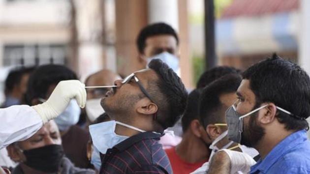 Medics collect swab samples of staff and students of Gauhati Medical College and Hospital for COVID-19 test after a PG student was tested positive for coronavirus, in Guwahati, Friday, May 8, 2020.(PTI)