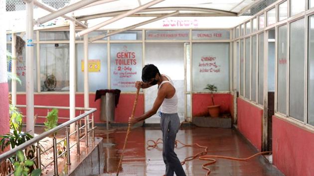 A worker cleans toilets at a bus station in Telangana, on Tuesday.(AFP Photo)