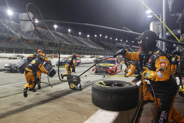 The pit crew for Martin Truex Jr. (19) moves into position during the NASCAR Cup Series auto race. (AP)