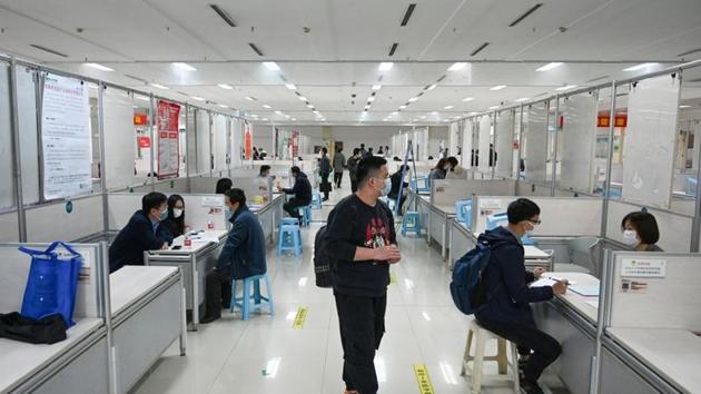 People wearing face masks to prevent the spread of the coronavirus disease attend a job fair in Hangzhou, Zhejiang province, China. (REUTERS) People wearing face masks to prevent the spread of the coronavirus disease attend a job fair in Hangzhou, Zhejiang province, China. (REUTERS)