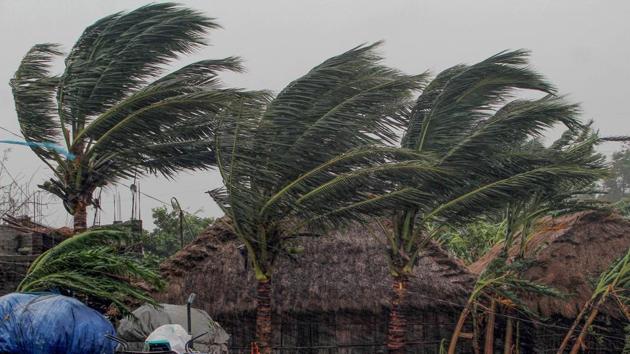 Trees sway as gusty winds induced by Cyclone Amphan hit near Dhamara Port in Odisha’s Bhadrak district, on Wednesday.(PTI Photo)