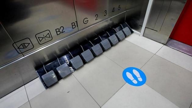 A mall in Thailand has swapped lift buttons for foot pedals.(Reuters)