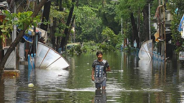 A man walks on a water-logged street after a flood in the area due to Cyclone Amphan, in Kolkata, Thursday, May 21, 2020.(PTI photo) A man walks on a water-logged street after a flood in the area due to Cyclone Amphan, in Kolkata, Thursday, May 21, 2020.(PTI photo)