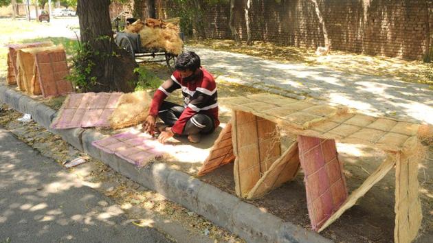 A street vendor readying cooler pads in Sector 45, Chandigarh, on Thursday. (Keshav Singh/HT) A street vendor readying cooler pads in Sector 45, Chandigarh, on Thursday. (Keshav Singh/HT)