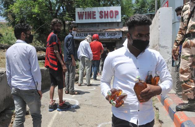 Serpentine queues were witnesses outside liquor shops on Day-1 of their reopening in Jammu on Thursday. (Nitin Kanora/HT)