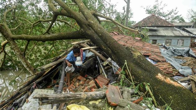A man salvages items from his house damaged by cyclone Amphan in Midnapore, West Bengal, on May 21, 2020. (AFP) A man salvages items from his house damaged by cyclone Amphan in Midnapore, West Bengal, on May 21, 2020. (AFP)
