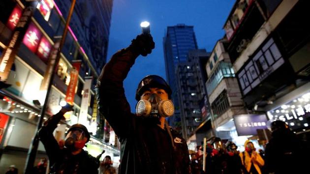 Demonstrators protesting the proposed extradition bill aim their flashlights towards riot police as they are chased through the streets of Hong Kong, China.(REUTERS)