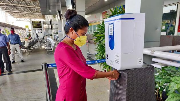 A woman uses a hand sanitizer dispenser at the Chennai airport as part of the preparations to resume services on May 25. With the spike in Coronavirus cases weighing heavily upon it, the Tamil Nadu government is not in favour of restarting domestic air services in the state till this month-end and might take up the matter with the Centre, reported PTI on May 22. (PTI) 