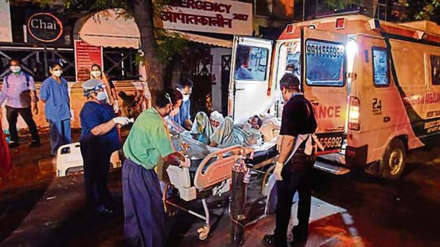 A patient being shifted from Cygnus Orthocare in Hauz Khas after a fire broke out. (Sanchit Khanna/HT) A patient being shifted from Cygnus Orthocare in Hauz Khas after a fire broke out. (Sanchit Khanna/HT)
