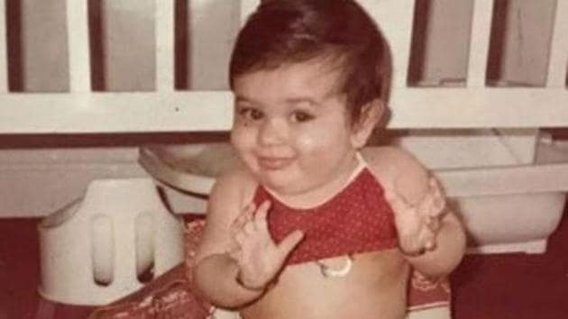 Kareena Kapoor flashing a cute smile as a little baby.