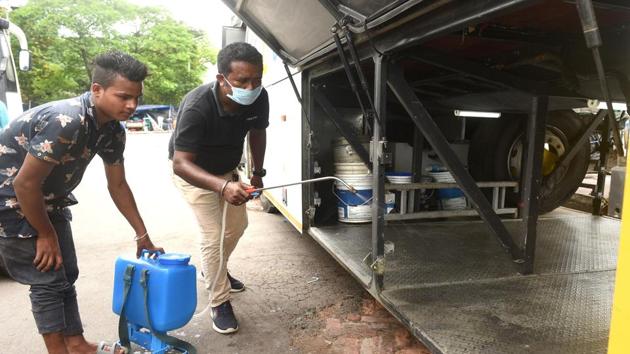 A bus operator sprays disinfectant on a bus which will carry passengers to Assam during the ongoing Covid-19 lockdown in Kolkata. (PTI File Photo) A bus operator sprays disinfectant on a bus which will carry passengers to Assam during the ongoing Covid-19 lockdown in Kolkata. (PTI File Photo)