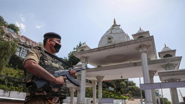 A security personnel stands guard at Katra Mata Vaishno Devi Darshani Deodi near Ban Ganga, during the ongoing nationwide COVID-19 lockdown, in Katra about 45km from Jammu, Saturday, May 23, 2020. (PTI) A security personnel stands guard at Katra Mata Vaishno Devi Darshani Deodi near Ban Ganga, during the ongoing nationwide COVID-19 lockdown, in Katra about 45km from Jammu, Saturday, May 23, 2020. (PTI)