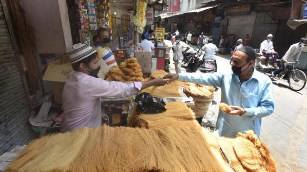 People seen at shops open for business ahead of Eid ul-Fitr festival at Jama Masjid in New Delhi. (Sonu Mehta/HT PHOTO) People seen at shops open for business ahead of Eid ul-Fitr festival at Jama Masjid in New Delhi. (Sonu Mehta/HT PHOTO)