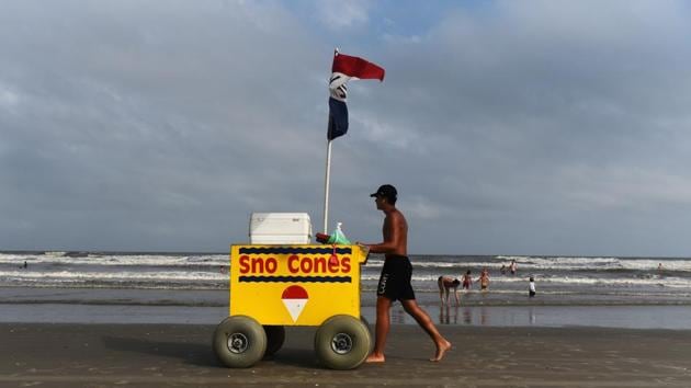 A man sells Sno Cones on the beach in Galveston, Texas. Many Memorial Day commemorations have been cancelled or downsized, including concerts and fireworks shows. (Callaghan O'Hare / REUTERS)