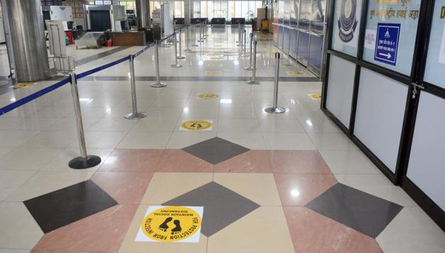 Signs on social distancing placed on the immigration office floor in Pune on Friday as domestic flights will begin operations from May 25.(SHANKAR NARAYAN/HT)