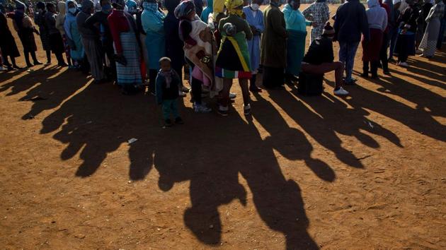 People stand in a queue to receive food at the Iterileng informal settlement near Laudium, Southwest of Pretoria, South Africa on May 20. The pandemic “appears to be taking a different pathway in Africa,” the World Health Organization has said. (Themba Hadebe / AP) People stand in a queue to receive food at the Iterileng informal settlement near Laudium, Southwest of Pretoria, South Africa on May 20. The pandemic “appears to be taking a different pathway in Africa,” the World Health Organization has said. (Themba Hadebe / AP)