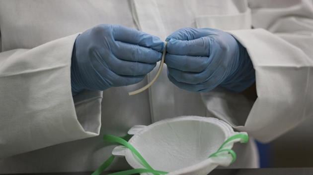 A worker adds nose protectors to face masks at a new factory in Mexico City, Thursday, May 21, 2020. An initiative by Mexico's National Autonomous University (UNAM) and Mexico City's government aims to fill the gap of the protective equipment desperately needed by doctors and nurses fighting the pandemic with this new factory to make N95 masks. (AP Photo/Fernando Llano) (AP) A worker adds nose protectors to face masks at a new factory in Mexico City, Thursday, May 21, 2020. An initiative by Mexico's National Autonomous University (UNAM) and Mexico City's government aims to fill the gap of the protective equipment desperately needed by doctors and nurses fighting the pandemic with this new factory to make N95 masks. (AP Photo/Fernando Llano) (AP)