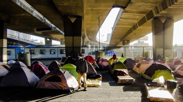 Homeless people living in tents under a bridge in Cape Town on May 22. Almost 3,200 people have died from COVID-19 across the continent of 1.3 billion people as of May 23. By comparison, when Europe reached 100,000 cases it had more than 4,000 deaths, the WHO noted. (AP) Homeless people living in tents under a bridge in Cape Town on May 22. Almost 3,200 people have died from COVID-19 across the continent of 1.3 billion people as of May 23. By comparison, when Europe reached 100,000 cases it had more than 4,000 deaths, the WHO noted. (AP)