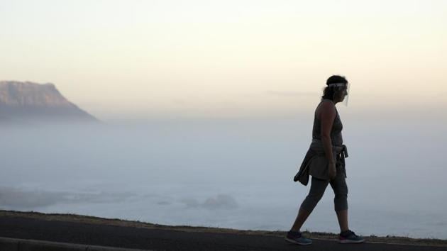 A woman wearing a face shield walks along a road in Clifton, Cape Town on May 22. The African continent saw roughly the same number of new cases in the past week as the week before, Africa CDC director John Nkengasong said on May 22 but the situation remains quite varied. In the past week, four African countries had an increase in virus cases of over 100%. (Nardus Engelbrecht / AP) A woman wearing a face shield walks along a road in Clifton, Cape Town on May 22. The African continent saw roughly the same number of new cases in the past week as the week before, Africa CDC director John Nkengasong said on May 22 but the situation remains quite varied. In the past week, four African countries had an increase in virus cases of over 100%. (Nardus Engelbrecht / AP)