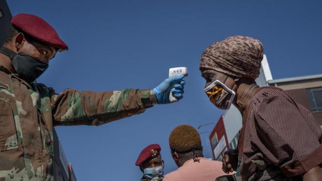 South African National Defence Forces thermal screen a person in Johannesburg's Alexandra township on May 20. Africa’s coronavirus cases stood at 104,279, according to the Africa Centers for Disease Control and Prevention dashboard on May 24. The continent with many fragile health systems has not seen the high numbers devastating other parts of the world. (Jerome Delay / AP) South African National Defence Forces thermal screen a person in Johannesburg's Alexandra township on May 20. Africa’s coronavirus cases stood at 104,279, according to the Africa Centers for Disease Control and Prevention dashboard on May 24. The continent with many fragile health systems has not seen the high numbers devastating other parts of the world. (Jerome Delay / AP)