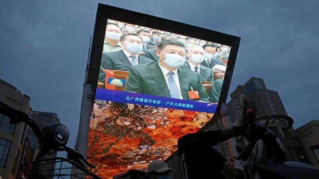 A giant screen displays news footage of Chinese President Xi Jinping wearing a face mask, following the coronavirus disease (COVID-19) outbreak, attending the opening session of the National People's Congress (NPC), in Beijing. (REUTERS) A giant screen displays news footage of Chinese President Xi Jinping wearing a face mask, following the coronavirus disease (COVID-19) outbreak, attending the opening session of the National People's Congress (NPC), in Beijing. (REUTERS)