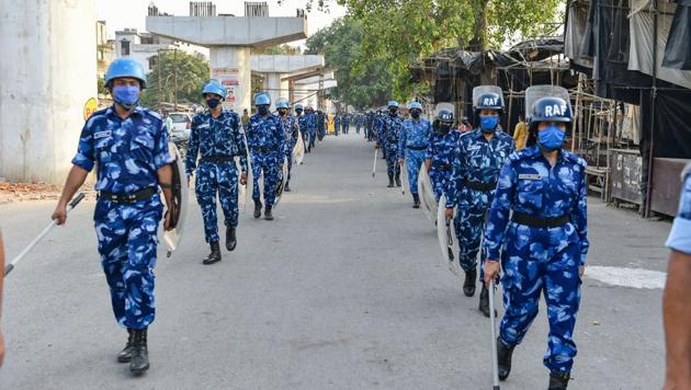 Rapid Action Force personnel conduct a flag march to enforce law and order during the Covid-19 lockdown, in Lucknow on Saturday.(PTI Photo)