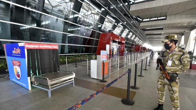 A CISF personnel looks at a baggage sanitizing machine placed at T3 Indira Gandhi International (IGI) Airport ahead of domestic flight services resuming. (Sanjeev Verma/HT PHOTO) A CISF personnel looks at a baggage sanitizing machine placed at T3 Indira Gandhi International (IGI) Airport ahead of domestic flight services resuming. (Sanjeev Verma/HT PHOTO)
