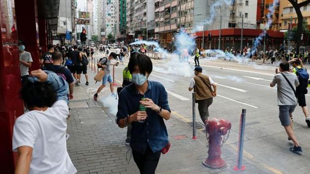 Anti-government protesters react as riot police fired tear gas to disperse them during a march. Demonstrations were already planned against the Beijing-backed legislation, including a bill that would criminalize disrespecting China’s national anthem, on May 24 and May 27. (Tyrone Siu / REUTERS) Anti-government protesters react as riot police fired tear gas to disperse them during a march. Demonstrations were already planned against the Beijing-backed legislation, including a bill that would criminalize disrespecting China’s national anthem, on May 24 and May 27. (Tyrone Siu / REUTERS)