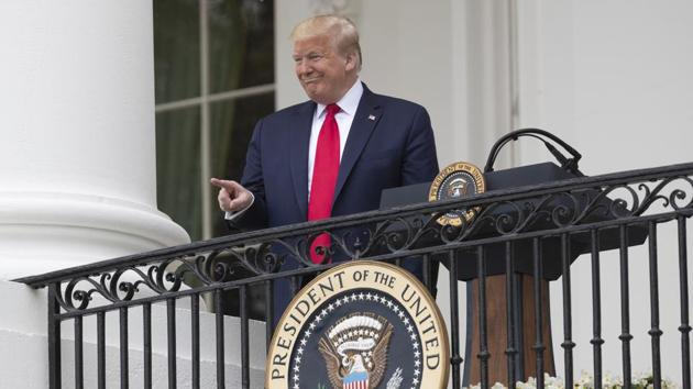 President Donald Trump points during a "Rolling to Remember Ceremony," to honor the nation's veterans and POW/MIA, from the Blue Room Balcony of the White House. (AP) President Donald Trump points during a "Rolling to Remember Ceremony," to honor the nation's veterans and POW/MIA, from the Blue Room Balcony of the White House. (AP)