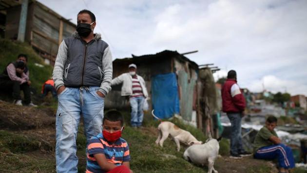 People, wearing masks, are seen on a field that, according to the mayor's office, is at high risk of collapse and its inhabitants will be evicted, amid the coronavirus disease (COVID-19) outbreak in Bogota, Colombia May 15, 2020. (REUTERS) People, wearing masks, are seen on a field that, according to the mayor's office, is at high risk of collapse and its inhabitants will be evicted, amid the coronavirus disease (COVID-19) outbreak in Bogota, Colombia May 15, 2020. (REUTERS)