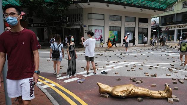 Bricks and a damaged store display lie scattered in the middle of a road during the protest in the Causeway Bay district. (Roy Liu / Bloomberg) Bricks and a damaged store display lie scattered in the middle of a road during the protest in the Causeway Bay district. (Roy Liu / Bloomberg)