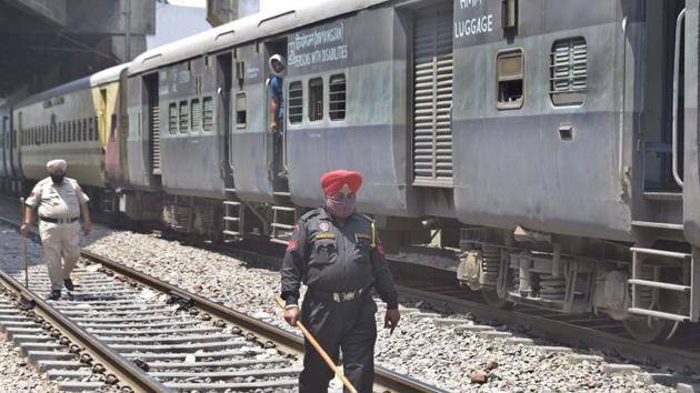 Police deployed on railway tracks near Jagroan bridge area to prevent illegal boarding on Shramik Special trains in Ludhiana on Saturday. (Gurpreet Singh/HT) Police deployed on railway tracks near Jagroan bridge area to prevent illegal boarding on Shramik Special trains in Ludhiana on Saturday. (Gurpreet Singh/HT)
