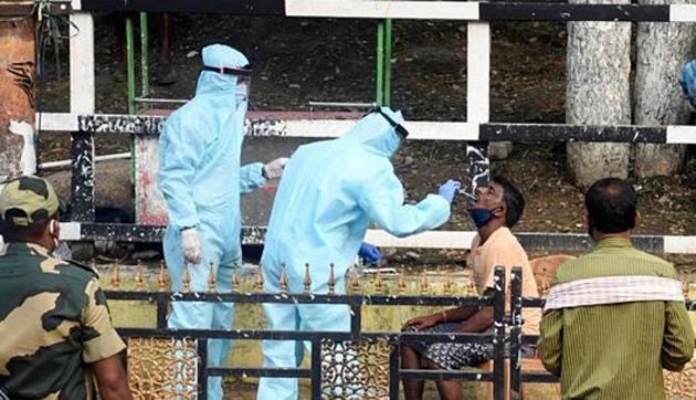 Medics collect swab samples of migrant workers for the COVID-19 test after a worker working in a potato godown at the fancy bazaar tested positive for coronavirus during the ongoing COVID-19 nationwide lockdown, in Guwahati on May 16, 2020. (ANI) Medics collect swab samples of migrant workers for the COVID-19 test after a worker working in a potato godown at the fancy bazaar tested positive for coronavirus during the ongoing COVID-19 nationwide lockdown, in Guwahati on May 16, 2020. (ANI)