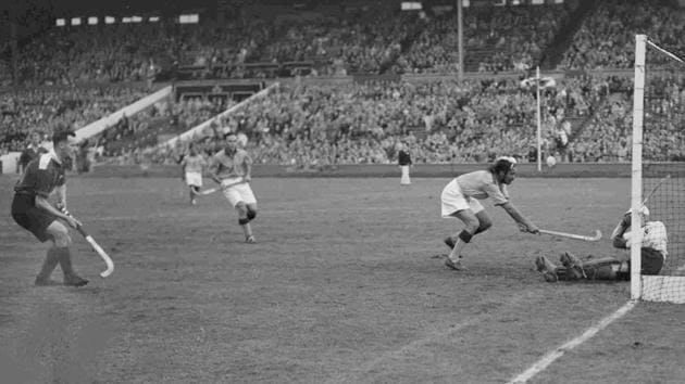 India's centre forward Balbir Singh, second right, tries to score a goal during the men's Olympic Games Hockey match against Great Britain, at Wembley Stadium, London, Aug. 12, 1948. Britain's goalkeeper D.L.S. Brodie saved the attempt and India won the match 4-0. (AP Photo)(AP)
