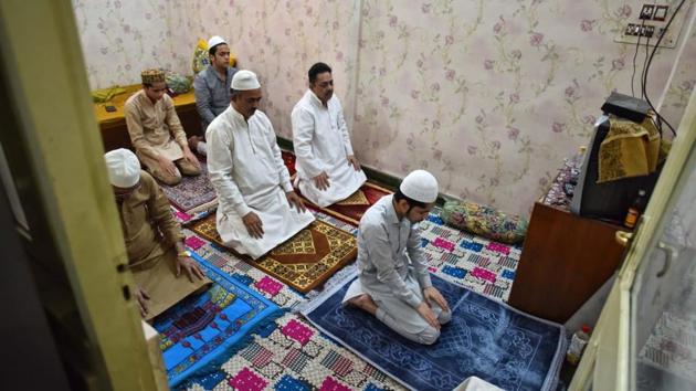 A Muslim family offers a special prayer in their home during the Eid-al-Fitr festival, which marks the end of Islamic holy fasting month of Ramadan, in New Delhi. (sanchit khanna/ht) A Muslim family offers a special prayer in their home during the Eid-al-Fitr festival, which marks the end of Islamic holy fasting month of Ramadan, in New Delhi. (sanchit khanna/ht)