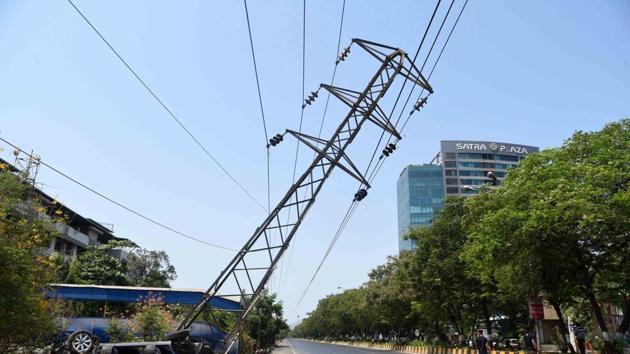 The MSEDCL power transmission tower tilted after a car crashed into it on Palm Beach Road at Vashi on Monday.
