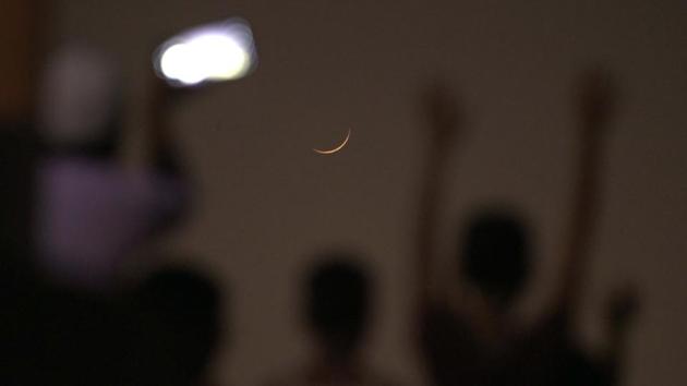 People celebrate and take pictures of the new crescent moon being sighted on the eve of Eid-ul-Fitr at IP Extension in New Delhi on May 24. The sighting brings and end to a month of fasting, self-reflection and peaceful contemplation. (Sushil Kumar / HT Photo) People celebrate and take pictures of the new crescent moon being sighted on the eve of Eid-ul-Fitr at IP Extension in New Delhi on May 24. The sighting brings and end to a month of fasting, self-reflection and peaceful contemplation. (Sushil Kumar / HT Photo)