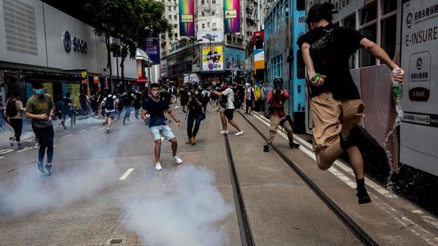 Protesters continue despite tear gas firing by the police on May 24. The proposed legislation is expected to ban treason, subversion and sedition, and follows repeated warnings from Beijing that it will no longer tolerate dissent in Hong Kong. (Issac Lawrence / AFP) Protesters continue despite tear gas firing by the police on May 24. The proposed legislation is expected to ban treason, subversion and sedition, and follows repeated warnings from Beijing that it will no longer tolerate dissent in Hong Kong. (Issac Lawrence / AFP)