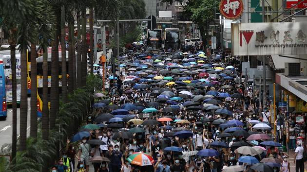 Demonstrators march with umbrellas in Wan Chai district. A joint statement issued by 199 legislators and politicians from 23 countries said that the protests are driven by “the genuine grievances of ordinary Hongkongers” and that harsh laws would only escalate the situation. (May James / Bloomberg) Demonstrators march with umbrellas in Wan Chai district. A joint statement issued by 199 legislators and politicians from 23 countries said that the protests are driven by “the genuine grievances of ordinary Hongkongers” and that harsh laws would only escalate the situation. (May James / Bloomberg)