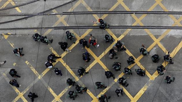 Riot police stand at a traffic intersection. According to Hong Kong police’s Facebook page, on May 24, officers would be deployed around Hong Kong at locations where unauthorized marches were due to take place. They also said they would arrest demonstrators if necessary. (May James / Bloomberg) Riot police stand at a traffic intersection. According to Hong Kong police’s Facebook page, on May 24, officers would be deployed around Hong Kong at locations where unauthorized marches were due to take place. They also said they would arrest demonstrators if necessary. (May James / Bloomberg)