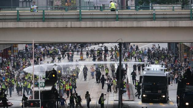 A police water cannon at work during the protest in Causeway Bay district. On their Facebook page, the Hong Kong police warned that anyone who gathers in groups of more than eight would violate the city’s social-distancing measures. (Roy Liu / Bloomberg) A police water cannon at work during the protest in Causeway Bay district. On their Facebook page, the Hong Kong police warned that anyone who gathers in groups of more than eight would violate the city’s social-distancing measures. (Roy Liu / Bloomberg)