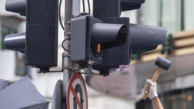 A demonstrator takes a mallet to a traffic light during the protest. China’s proposed security law for Hong Kong was “anti-virus software” for the city to enhance law and order, and to build a stable foundation for the principle of one country, two systems, the Communist Party-owned People’s Daily said in an online commentary on May 23. (Justin Chin / Bloomberg) A demonstrator takes a mallet to a traffic light during the protest. China’s proposed security law for Hong Kong was “anti-virus software” for the city to enhance law and order, and to build a stable foundation for the principle of one country, two systems, the Communist Party-owned People’s Daily said in an online commentary on May 23. (Justin Chin / Bloomberg)