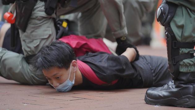 A protester is overpowered and detained by Hong Kong’s riot police during a demonstration against Beijing’s national security legislation in Causeway Bay on May 24. Meanwhile, Hong Kong Chief Executive Carrie Lam said the city would cooperate fully with China to enact the legislation. (Vincent Yu / AP) A protester is overpowered and detained by Hong Kong’s riot police during a demonstration against Beijing’s national security legislation in Causeway Bay on May 24. Meanwhile, Hong Kong Chief Executive Carrie Lam said the city would cooperate fully with China to enact the legislation. (Vincent Yu / AP)