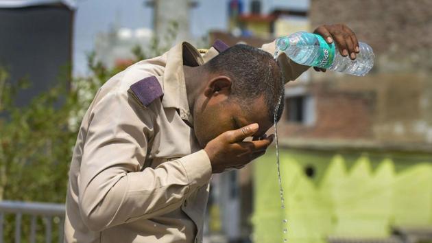 A security personnel splashes water on his head to beat the heat in Prayagraj on May 25. (PTI) A security personnel splashes water on his head to beat the heat in Prayagraj on May 25. (PTI)