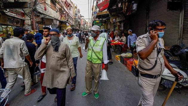 A Civil Defence volunteer makes announcements on a loudspeaker as people gather for last minute shopping on the eve of Eid in Old Delhi on May 24. Markets in the area, a major draw for food and shopping well into the early of the day throughout Ramzan sprung back only after relaxations in the capital’s lockdown conditions. (Manvender Vashist / PTI) A Civil Defence volunteer makes announcements on a loudspeaker as people gather for last minute shopping on the eve of Eid in Old Delhi on May 24. Markets in the area, a major draw for food and shopping well into the early of the day throughout Ramzan sprung back only after relaxations in the capital’s lockdown conditions. (Manvender Vashist / PTI)