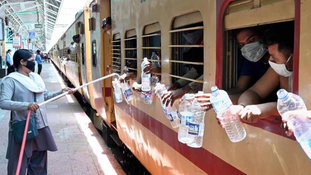 A railway employee refills water bottles of migrant workers sitting inside a special train bound to their home state amid the lockdown in Jabalpur, on May 23. IMD’s bulletin added that heatwave conditions were likely over Punjab, Haryana, Chandigarh, Delhi, Rajasthan, Uttar Pradesh, Madhya Pradesh, Vidarbha (Maharashtra) and Telangana over the next 4-5 days. (PTI) A railway employee refills water bottles of migrant workers sitting inside a special train bound to their home state amid the lockdown in Jabalpur, on May 23. IMD’s bulletin added that heatwave conditions were likely over Punjab, Haryana, Chandigarh, Delhi, Rajasthan, Uttar Pradesh, Madhya Pradesh, Vidarbha (Maharashtra) and Telangana over the next 4-5 days. (PTI)