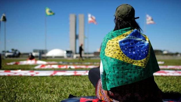 A demonstrator seen sitting in front of the National Congress in Brasilia. “South America has become a new epicentre for the disease,” WHO emergencies director Mike Ryan said on May 22. “We’ve seen many South American countries with increasing numbers of cases... but certainly the most affected is Brazil at this point.” (Adriano Machado / REUTERS) A demonstrator seen sitting in front of the National Congress in Brasilia. “South America has become a new epicentre for the disease,” WHO emergencies director Mike Ryan said on May 22. “We’ve seen many South American countries with increasing numbers of cases... but certainly the most affected is Brazil at this point.” (Adriano Machado / REUTERS)